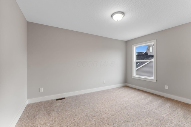 empty room with carpet flooring