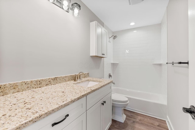 full bathroom with wood-type flooring, vanity, toilet, and tiled shower / bath combo