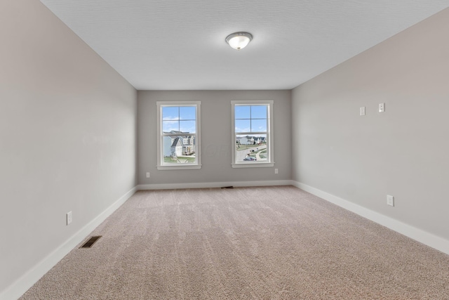 empty room with light colored carpet