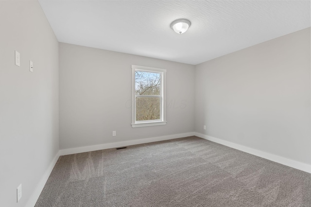 unfurnished room with carpet flooring