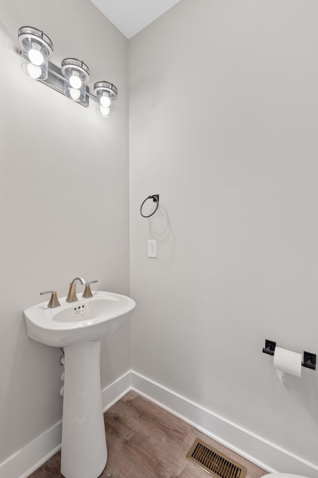 bathroom with hardwood / wood-style floors