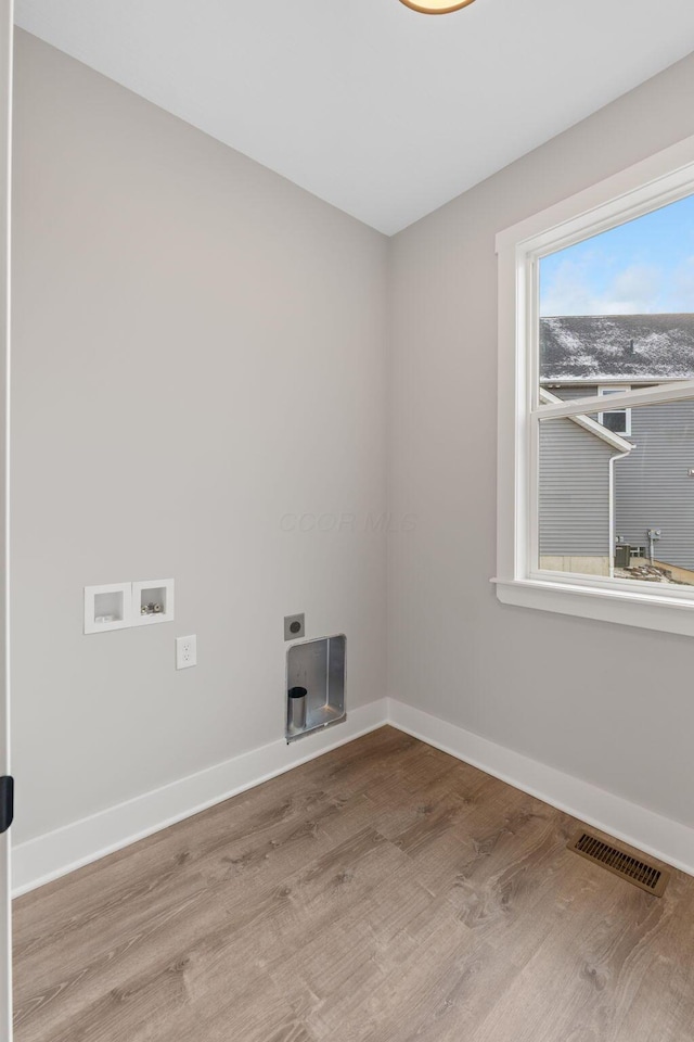 washroom with electric dryer hookup, light wood-type flooring, and hookup for a washing machine