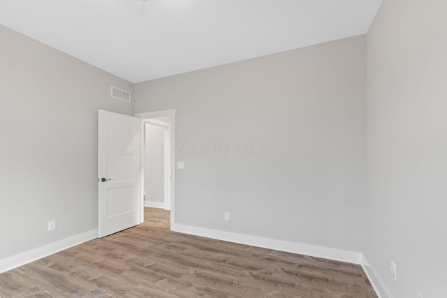 unfurnished room with light hardwood / wood-style floors