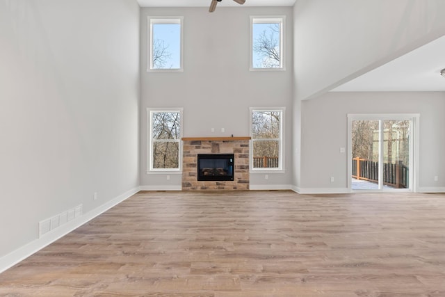 unfurnished living room with ceiling fan and light hardwood / wood-style floors