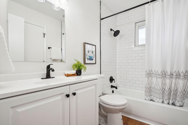 full bathroom featuring hardwood / wood-style floors, vanity, toilet, and shower / bath combo with shower curtain