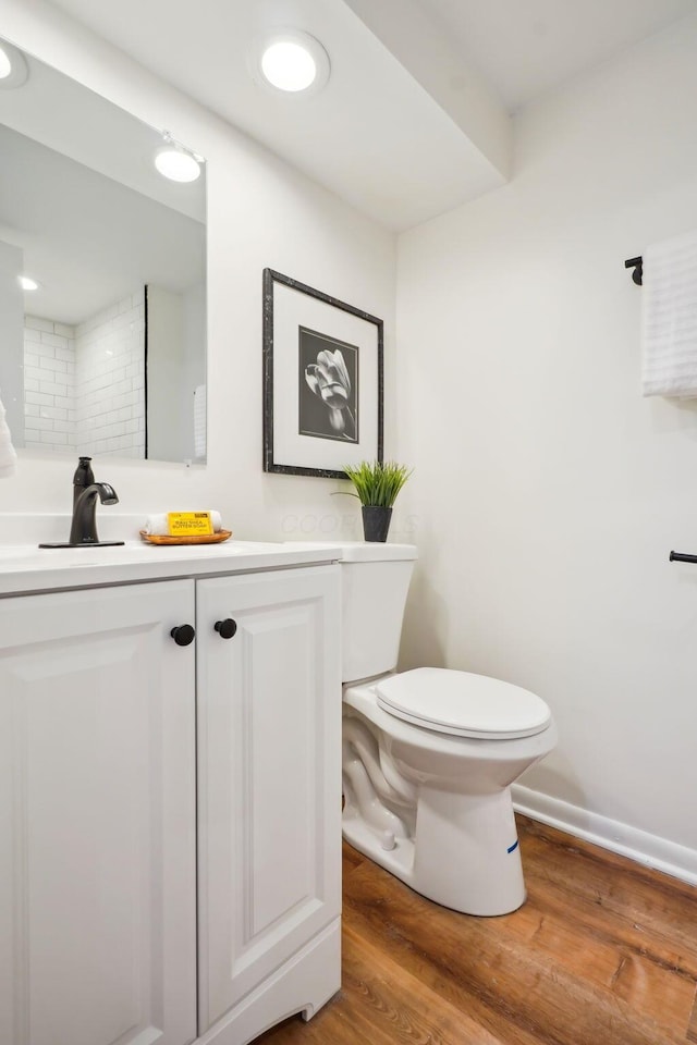 bathroom featuring hardwood / wood-style floors, vanity, and toilet