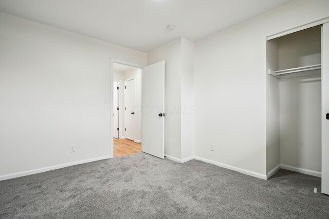 unfurnished bedroom with carpet floors and a closet