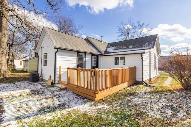 back of property with central AC and a deck