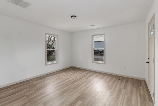 unfurnished room with light hardwood / wood-style floors