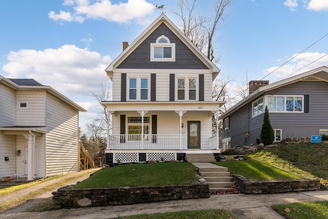 view of front of property featuring covered porch and a front yard