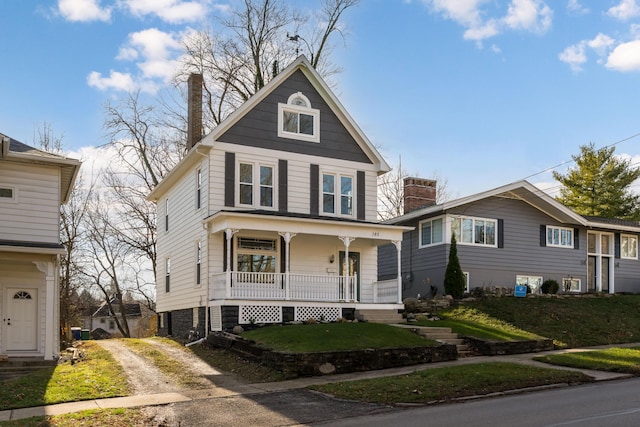 view of front of home with a porch and a front yard