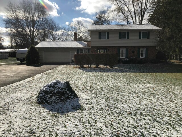 rear view of property with a garage