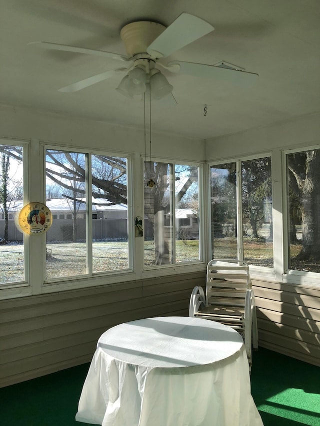 sunroom / solarium featuring ceiling fan