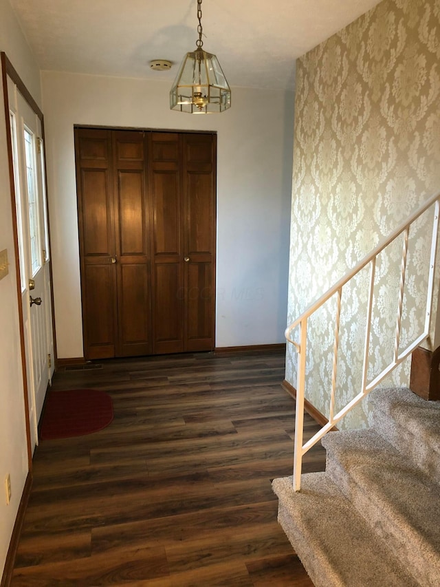 entryway featuring a chandelier and dark hardwood / wood-style flooring