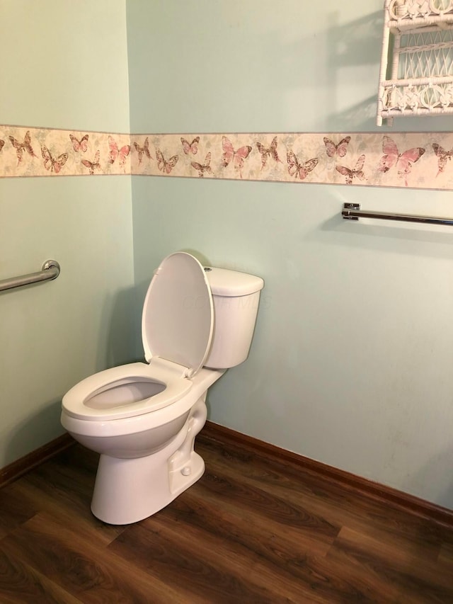 bathroom with hardwood / wood-style floors and toilet