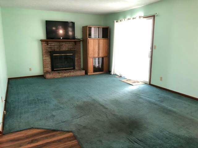 unfurnished living room with a brick fireplace