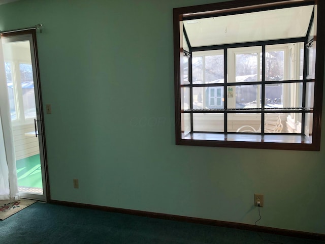 carpeted spare room featuring a wealth of natural light