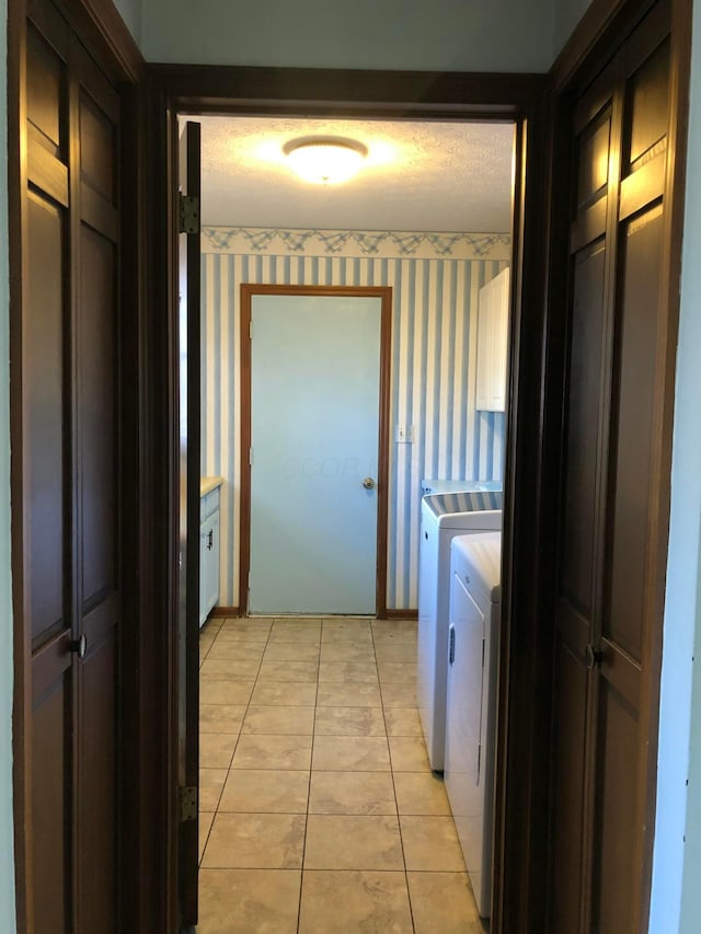 laundry area with light tile patterned floors and separate washer and dryer