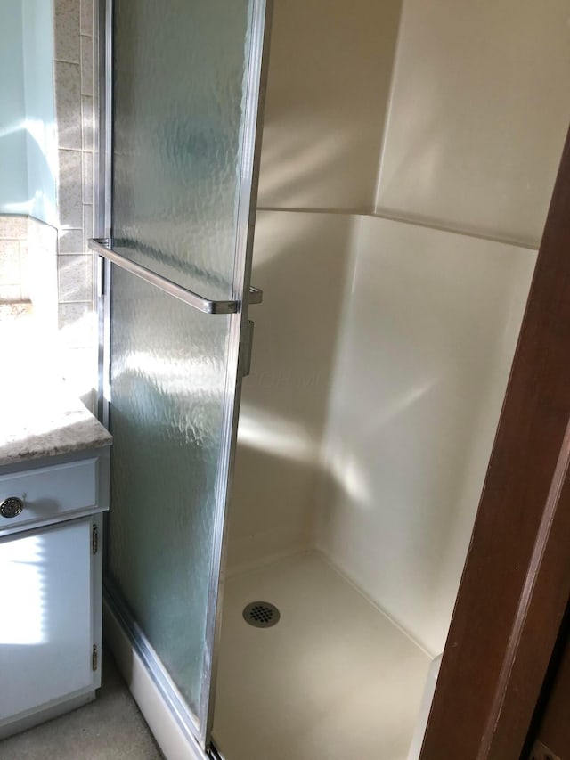 room details featuring a shower with door