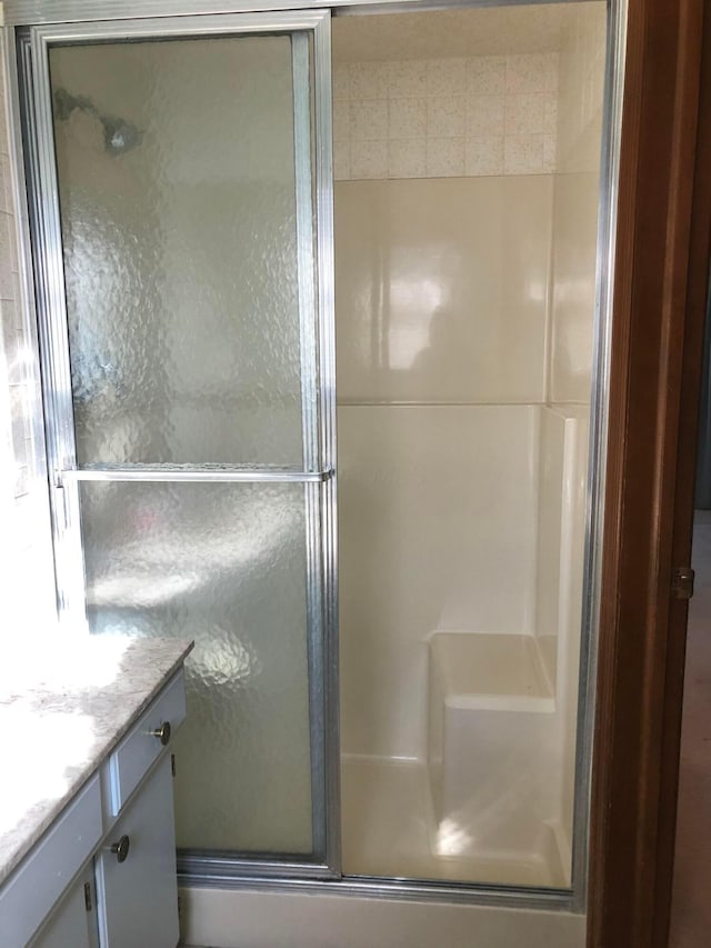 bathroom with vanity and an enclosed shower