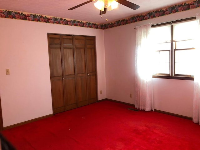 unfurnished bedroom with carpet flooring, ceiling fan, and a closet