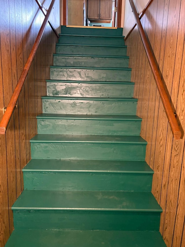 staircase with wooden walls