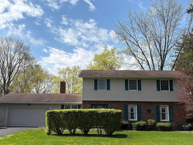 1667 Marion Edison Rd, Marion, OH 43302 - colonial inspired home featuring driveway, a chimney, a front yard, an attached garage, and brick siding