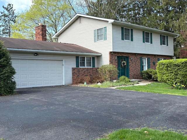 1667 Marion Edison Rd, Marion, OH 43302 - view of front facade featuring a garage, brick siding, a chimney, and driveway
