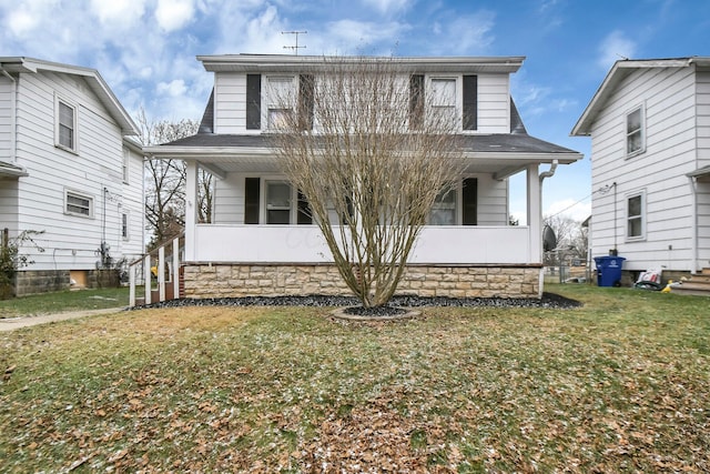 view of front of home with a porch and a front yard