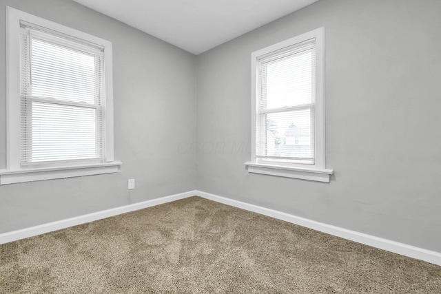 empty room with carpet and baseboards