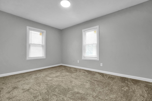 empty room with carpet floors and baseboards