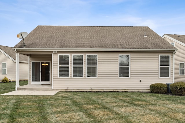 rear view of house featuring a yard and a patio