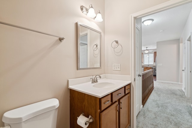 bathroom featuring ceiling fan, toilet, and vanity