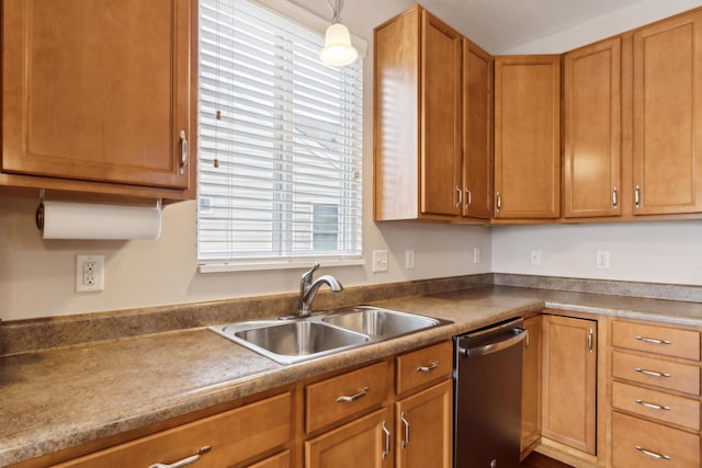 kitchen featuring dishwasher, decorative light fixtures, and sink