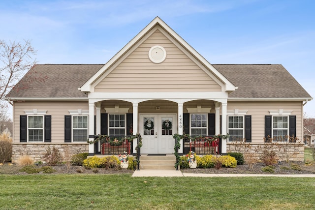 view of front of property with a porch and a front lawn