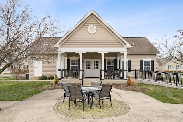 exterior space with covered porch and a lawn