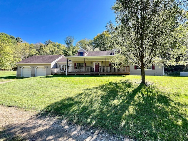 view of front of house featuring a garage, covered porch, and a front lawn