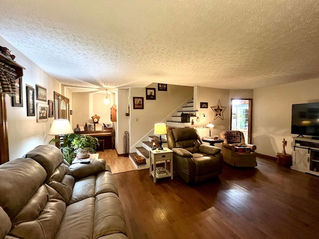 living room with hardwood / wood-style flooring and a textured ceiling