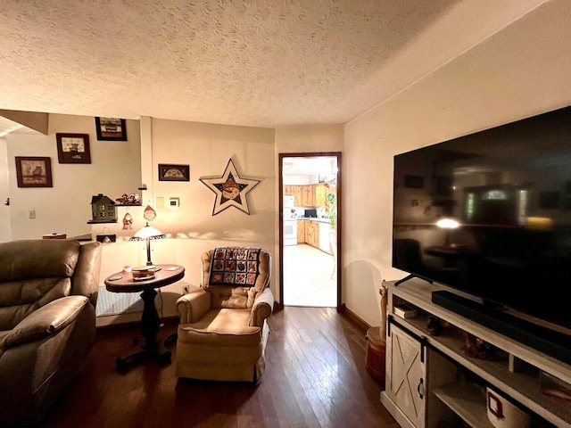 living room with dark wood-type flooring and a textured ceiling