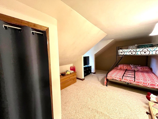 bedroom featuring carpet flooring and vaulted ceiling