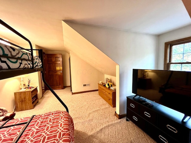 carpeted bedroom with lofted ceiling