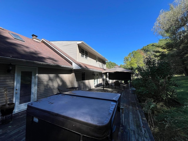 deck featuring a hot tub