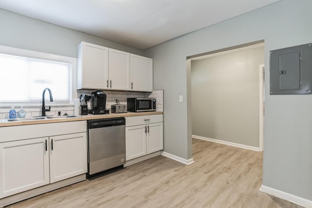 kitchen with electric panel, sink, light wood-type flooring, appliances with stainless steel finishes, and white cabinetry