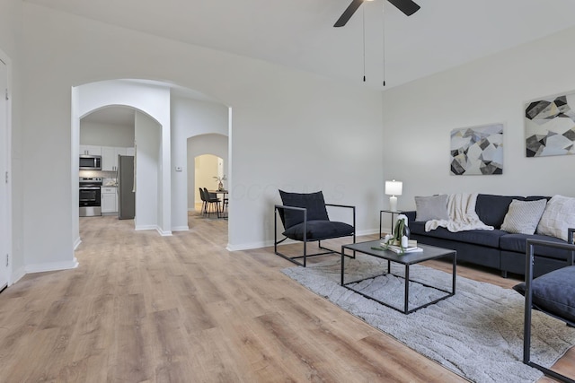 living room featuring ceiling fan and light hardwood / wood-style flooring