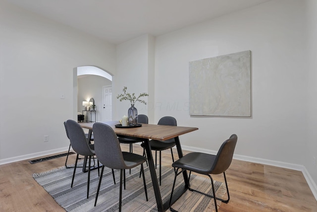 dining area with hardwood / wood-style floors