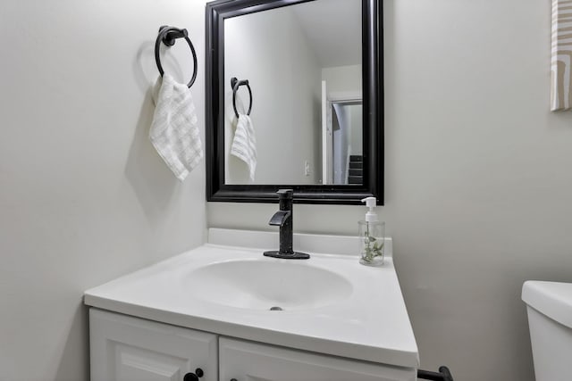 bathroom featuring vanity and toilet