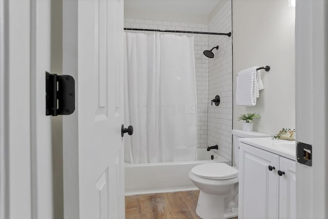 full bathroom with vanity, hardwood / wood-style flooring, toilet, and shower / bathtub combination with curtain