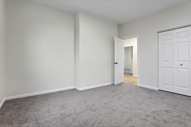 unfurnished bedroom with carpet and a closet