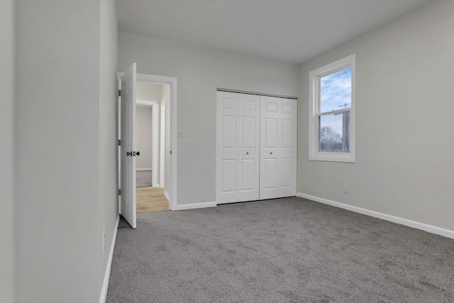 unfurnished bedroom featuring carpet and a closet