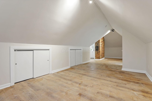 bonus room featuring light hardwood / wood-style flooring and vaulted ceiling